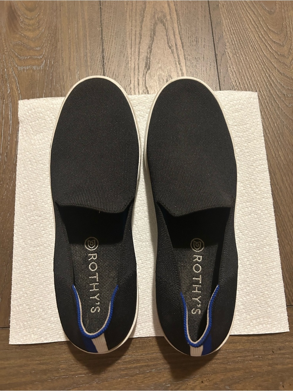 Rothy's Black Slip-On Knit Sneakers with White Sole and Blue Heel Detail